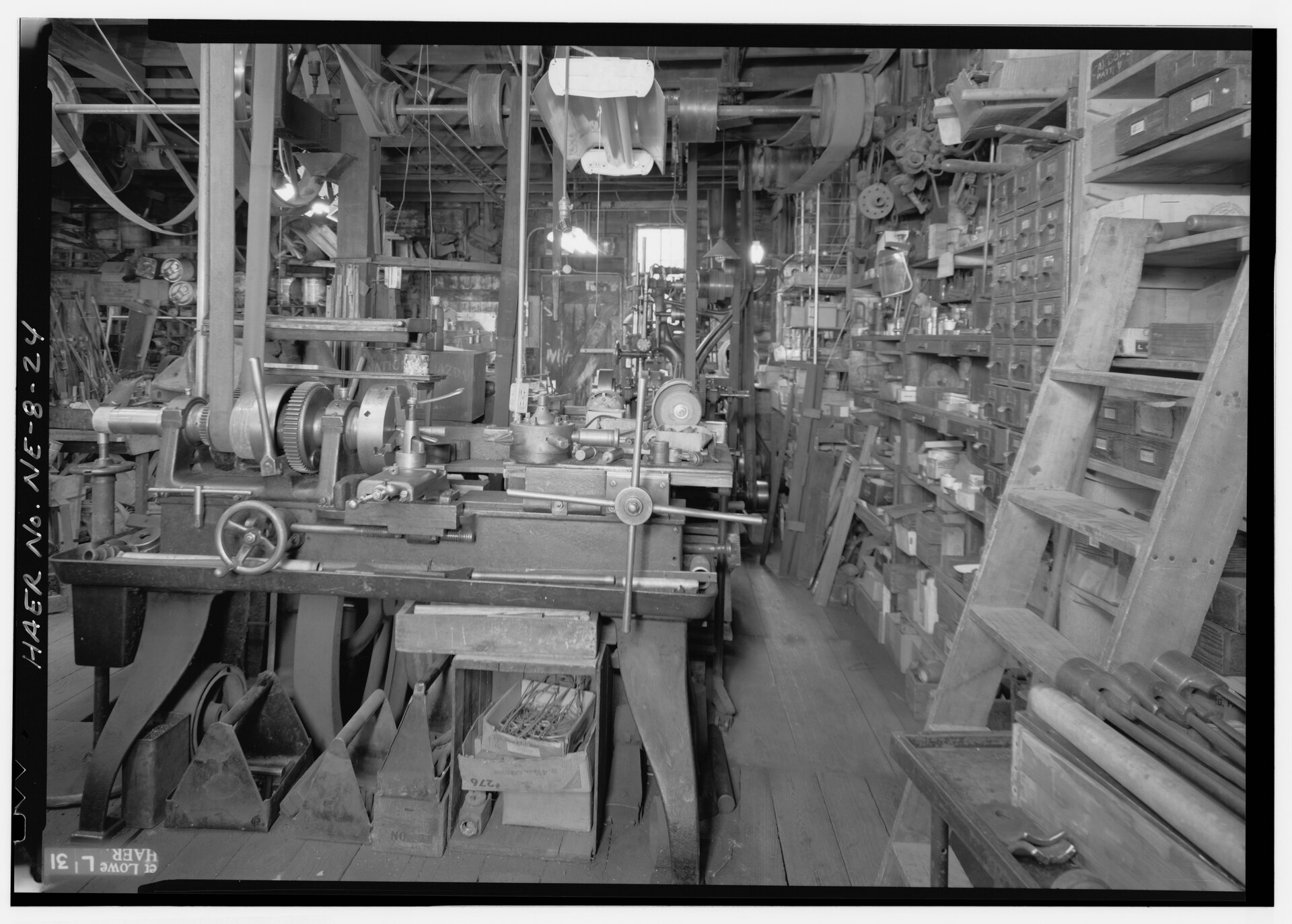 A machine shop with an overhead line shaft and belts