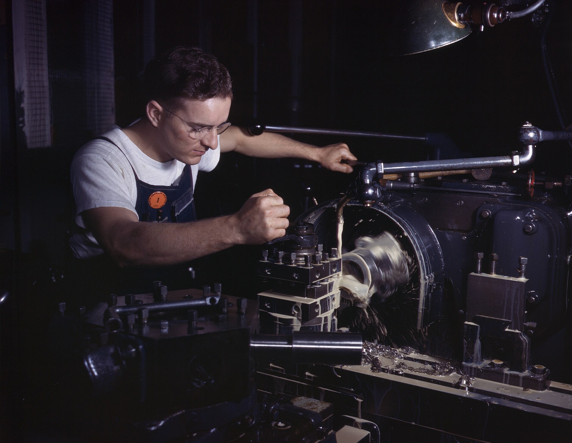 A machinist at a motor-driven turret lathe