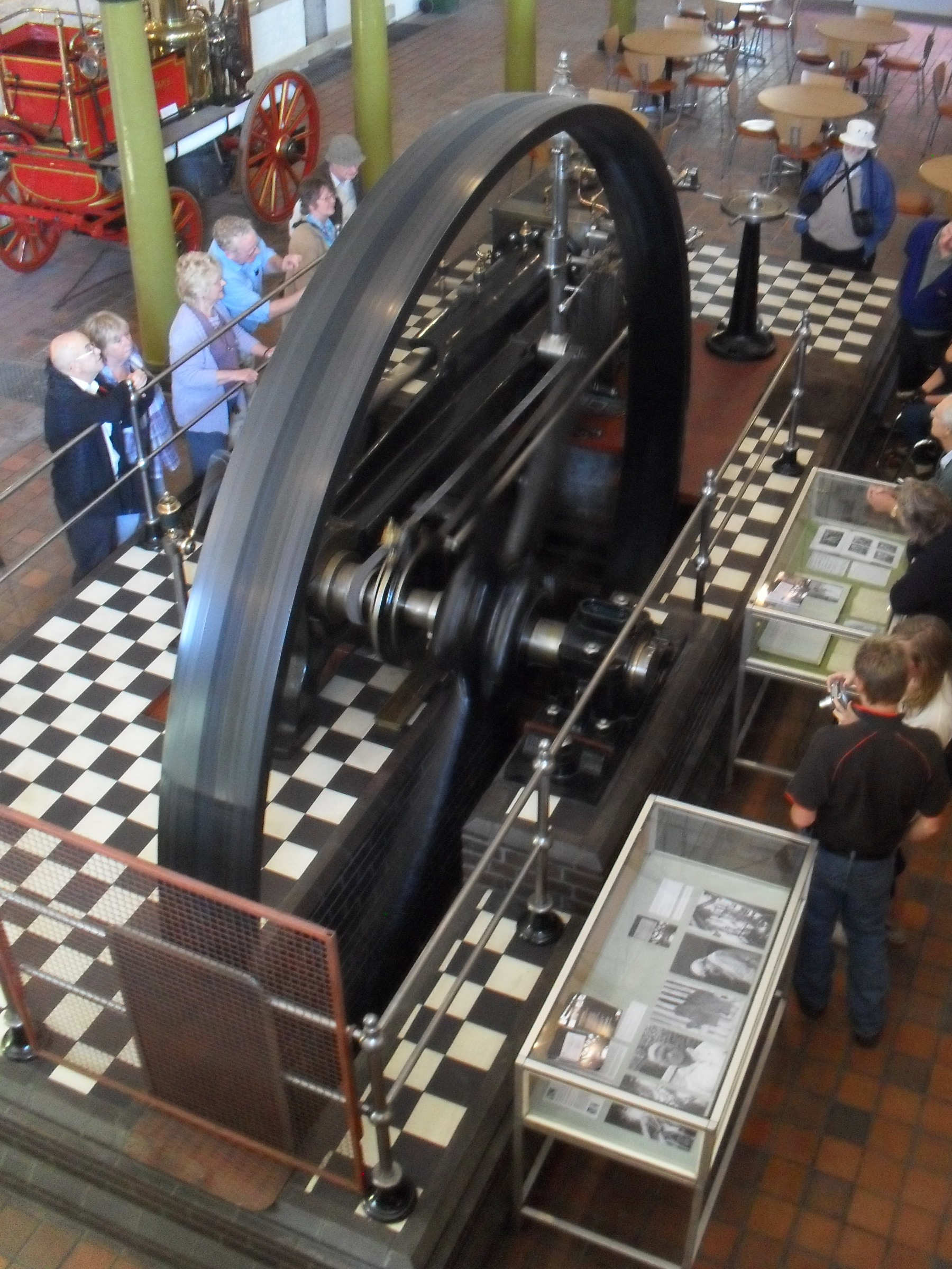 A large Corliss steam engine with a huge flywheel in a museum
